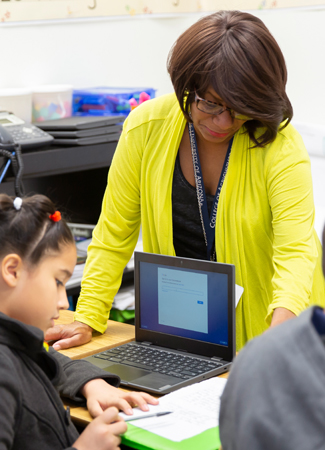 Photo: Teacher showing student on paper